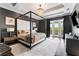 Main bedroom with canopy bed, balcony access, and TV at 4902 Carranza Ct, Tampa, FL 33616
