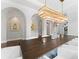 Modern dining room with a large wooden table and statement lighting at 4902 Carranza Ct, Tampa, FL 33616