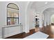 Bright entryway with hardwood floors, arched doorways, and a console table at 4902 Carranza Ct, Tampa, FL 33616