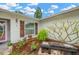 Landscaped front yard with wooden bench and various plants at 520 Bryan Valley Ct, Brandon, FL 33511