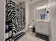 Well-lit bathroom with white vanity and zebra print accents at 5709 Camila Song Ln, Tampa, FL 33625