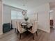 Bright dining room featuring a wood table and six beige chairs at 5709 Camila Song Ln, Tampa, FL 33625