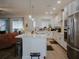 Open concept kitchen with white cabinets, island and stainless steel appliances at 5709 Camila Song Ln, Tampa, FL 33625