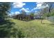 Spacious backyard featuring a pool and screened enclosure at 628 Erin Way, Brooksville, FL 34601