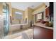 Spa-like bathroom with a soaking tub, glass shower, and updated vanity at 628 Erin Way, Brooksville, FL 34601