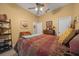 Charming bedroom with a full bed, ceiling fan, and built-in shelving at 628 Erin Way, Brooksville, FL 34601