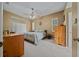 Main bedroom with a ceiling fan, large windows and wooden furniture at 628 Erin Way, Brooksville, FL 34601