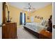 Bright bedroom with a queen-size bed, ceiling fan, and ample closet space at 628 Erin Way, Brooksville, FL 34601