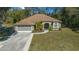 Single-story house with a two car garage and a well maintained lawn at 628 Erin Way, Brooksville, FL 34601