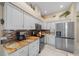 Kitchen with granite countertops, white cabinets, and stainless steel appliances at 628 Erin Way, Brooksville, FL 34601