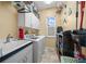 Bright laundry room includes washer, dryer, and ample storage space at 628 Erin Way, Brooksville, FL 34601