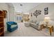 Bright living room featuring a sectional sofa and access to the backyard at 628 Erin Way, Brooksville, FL 34601