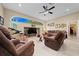 Spacious living room featuring a cozy seating area and large windows at 628 Erin Way, Brooksville, FL 34601