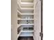 Walk-in pantry with ample shelving for storage at 6920 Crestpoint Dr, Apollo Beach, FL 33572