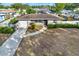 Aerial view shows charming house with driveway and landscaping at 7095 17Th N Way, St Petersburg, FL 33702