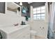 Updated bathroom with white vanity, subway tile, and decorative accents at 7095 17Th N Way, St Petersburg, FL 33702