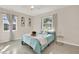 Cozy bedroom with light teal bedding and plenty of natural light at 7095 17Th N Way, St Petersburg, FL 33702