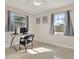 Bright home office features a glass desk, comfortable chair, and natural light at 7095 17Th N Way, St Petersburg, FL 33702