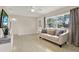 Living room features hardwood floors, large windows, and a comfy sofa at 7095 17Th N Way, St Petersburg, FL 33702