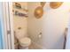 Clean bathroom with toilet and floating shelves at 7520 Sunshine Skyway S Ln # T18, St Petersburg, FL 33711