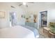 Bright bedroom with a dresser and access to a closet at 7520 Sunshine Skyway S Ln # T18, St Petersburg, FL 33711