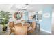 Bright dining area with a round wooden table and four wicker chairs at 7520 Sunshine Skyway S Ln # T18, St Petersburg, FL 33711
