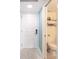 Bright entryway with white door and access to a half-bathroom at 7520 Sunshine Skyway S Ln # T18, St Petersburg, FL 33711