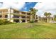 Exterior of the building showcasing landscaping and balconies at 7520 Sunshine Skyway S Ln # T18, St Petersburg, FL 33711
