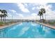 Refreshing community pool with waterfront views and lounge chairs at 7520 Sunshine Skyway S Ln # T18, St Petersburg, FL 33711