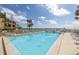 Inviting community pool with lounge chairs and waterfront view at 7520 Sunshine Skyway S Ln # T18, St Petersburg, FL 33711