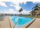 Community pool with lounge chairs and waterfront view at 7520 Sunshine Skyway S Ln # T18, St Petersburg, FL 33711