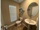 Small bathroom with pedestal sink and window at 8365 Capstone Ranch Dr, New Port Richey, FL 34655