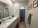 Double vanity bathroom with a shower at 8365 Capstone Ranch Dr, New Port Richey, FL 34655
