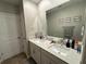 Double vanity bathroom with a mirror at 8365 Capstone Ranch Dr, New Port Richey, FL 34655
