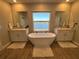 Elegant bathroom with double vanity and soaking tub at 8365 Capstone Ranch Dr, New Port Richey, FL 34655
