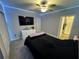 Well-lit bedroom featuring a TV and en-suite bathroom access at 8365 Capstone Ranch Dr, New Port Richey, FL 34655