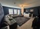 Bright bonus room featuring a sectional sofa and entertainment center at 8365 Capstone Ranch Dr, New Port Richey, FL 34655