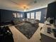 Bright bonus room featuring a sectional sofa and entertainment center at 8365 Capstone Ranch Dr, New Port Richey, FL 34655