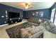Bonus room with sectional sofa, large TV, and media components at 8365 Capstone Ranch Dr, New Port Richey, FL 34655