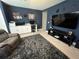 Bonus room with large TV, sectional sofa, and workspace at 8365 Capstone Ranch Dr, New Port Richey, FL 34655