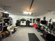 Spacious garage with storage, gym area, and workbench at 8365 Capstone Ranch Dr, New Port Richey, FL 34655
