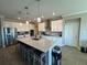 Modern kitchen with large island, stainless steel appliances, and white cabinets at 8365 Capstone Ranch Dr, New Port Richey, FL 34655