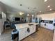 Open concept kitchen features a large island and breakfast bar at 8365 Capstone Ranch Dr, New Port Richey, FL 34655