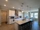 Spacious kitchen with island, stainless steel appliances, and white cabinets at 8365 Capstone Ranch Dr, New Port Richey, FL 34655