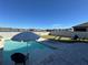 Inviting pool area with lounge chairs and umbrella at 8365 Capstone Ranch Dr, New Port Richey, FL 34655