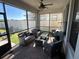 Cozy screened porch with wicker furniture and ceiling fan at 8365 Capstone Ranch Dr, New Port Richey, FL 34655