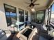 Spacious screened porch with wicker furniture and view at 8365 Capstone Ranch Dr, New Port Richey, FL 34655