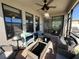 Spacious screened porch with wicker furniture and sliding door at 8365 Capstone Ranch Dr, New Port Richey, FL 34655
