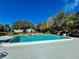 Community pool with gazebo and surrounding trees at 8651 10Th N St # 128, St Petersburg, FL 33702