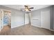 Bright bedroom with ceiling fan, wood-look floors, and ample closet space at 9626 Charlesberg Dr, Tampa, FL 33635